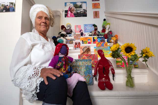 Artist Sumaya Evans sits with her installation &quot;dignity dolls.&quot; part of an exhibit titled &quot;Where Has All The (affordable) Housing Gone?&quot; at the Beyond Baroque gallery, Friday, Nov. 3, 2023, in the Venice Beach area of Los Angeles. Evans, who was homeless in Venice for years before recently finding housing, said creating art gave her a sense of self-worth when she was living on the streets. &quot;You get used to being ignored as a homeless woman. People are blind to you when you&#39;re outside,&quot; she said. &quot;And so being a part of a project like this, being a part of a community, is just so healing.&quot; (AP Photo/Richard Vogel)