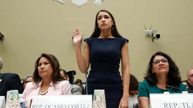 Rep. Alexandria Ocasio-Cortez (D-N.Y.) stands to be sworn in before she testifies before the House Oversight Committee hearing on family separation and detention centers, July 12, 2019, on Capitol Hill, flanked on her left by Rep. Veronica Escobar (D-Texas) and Rep. Rashida Tlaib (D-Mich.).