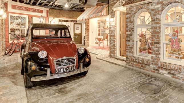 Image for article titled There&#39;s Life-Sized Fake Town Complete With Real Cars In This Mansion&#39;s Basement