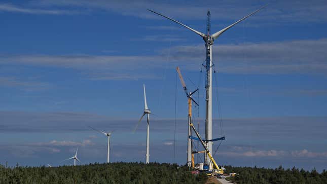 Workers install a wind turbines on September 9, 2020 in the Ardeche mountain near Lanarce, central France. 
