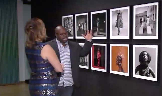 Kwame S. Brathwaite, right, discusses the work of his father, photographer Kwame Brathwaite with reporter Kemberly Richardson.