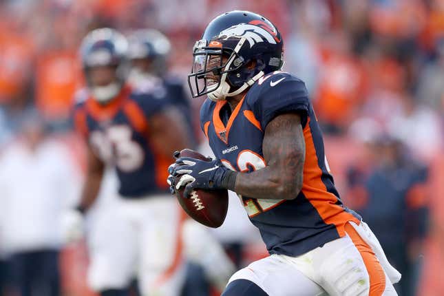 Kareem Jackson #22 of the Denver Broncos carries the ball after making an interception against the Tennessee Titans in the fourth quarter at Broncos Stadium at Mile High on October 13, 2019 in Denver, Colorado. 