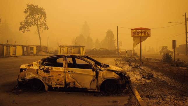 A charred vehicle is seen in the parking lot of the burned Oak Park Motel after the passage of the Santiam Fire in Gates, Oregon on September 10, 2020.