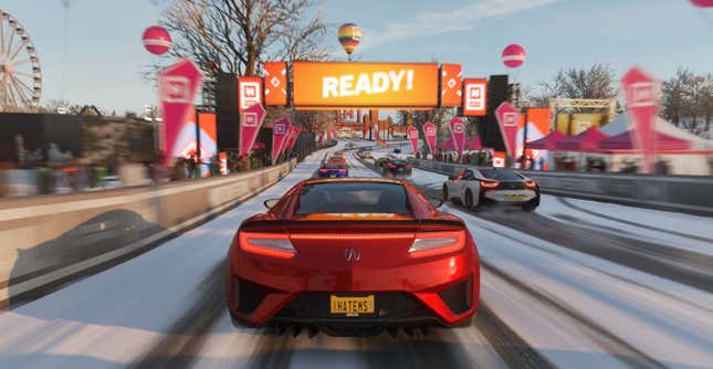 Red car at the start of a snow race.