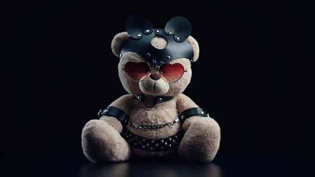 A teddy bear dressed in kinky leather attire. 