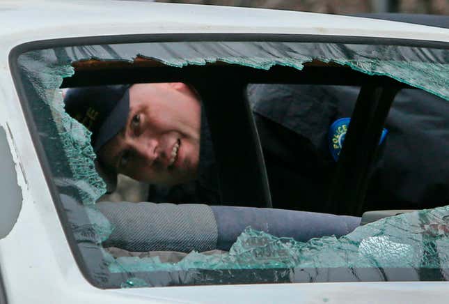 A St. Louis Police crime scene investigator looks over a car with the windows shot out on Thursday, March 14, 2019, near the corner of S. Grand Blvd. and Utah Street in St. Louis. Police were first called to the scene with a reported carjacking. 