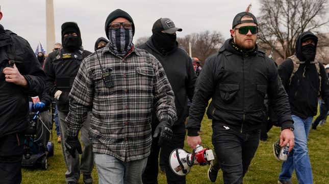 Proud Boy members Joseph Biggs, left, and Ethan Nordean, right with megaphone, walk toward the U.S. Capitol in Washington, Jan. 6, 2021.