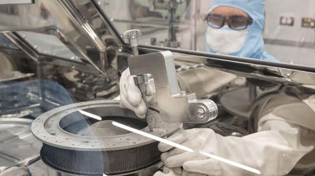 NASA’s OSIRIS-REx curation engineer, Neftali Hernandez, attaches one of the tools developed to help remove two final fasteners that prohibited complete disassembly of the TAGSAM (Touch-and-Go Sample Acquisition Mechanism) head.