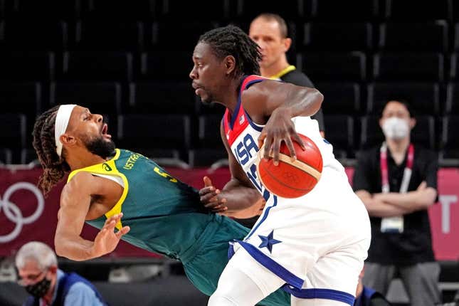 Aug 5, 2021; Saitama, Japan; United States guard Jrue Holiday (12) drives to the basket against Australia point guard Patty Mills (5) in the men&#39;s basketball semi final during the Tokyo 2020 Olympic Summer Games at Saitama Super Arena.