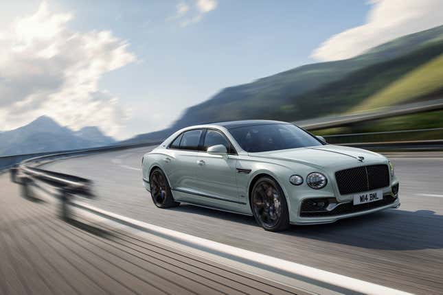 Image of a 2023 Bentley Flying Spur Speed Edition 12 in a light greenish grey color obviously traveling at high speeds on a track.