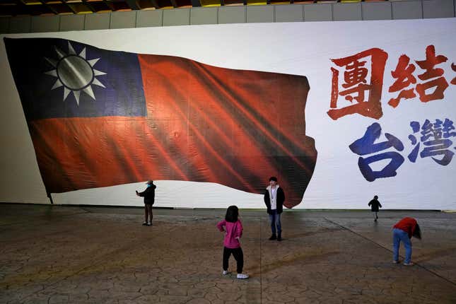 Children play in front of an image of a Taiwanese national flag as votes are counted in New Taipei City, Taiwan, Saturday, Jan. 13, 2024. Polls closed Saturday after Taiwanese cast their votes for a new president and legislature in an election that could chart the trajectory of the self-ruled democracy&#39;s relations with China over the next four years. (AP Photo/Ng Han Guan)