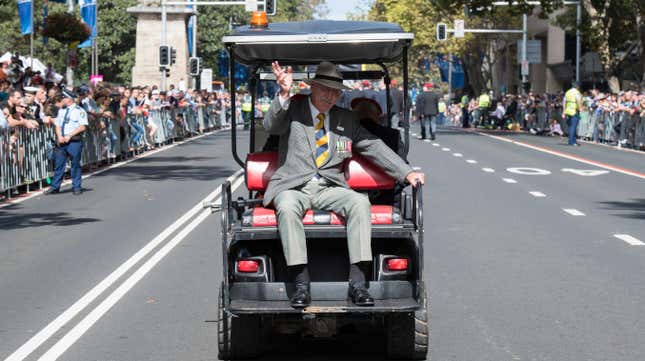 A veteran gets a lift on a golf buggy whilst in the Anzac Day march on Elizabeth Street on April 25, 2018 in Sydney, Australia.
