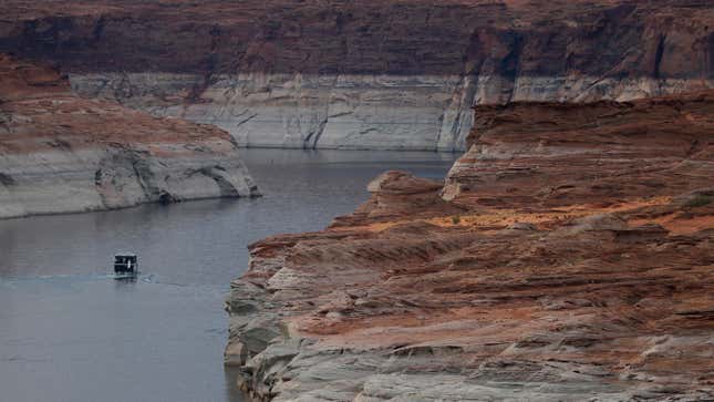 A boat navigates the waters Lake Powell on June 24, 2021 in Page, Arizona. As severe drought grips parts of the Western United States, a below average flow of water is expected to flow through the Colorado River Basin into two of its biggest reservoirs, Lake Powell and Lake Mead. 