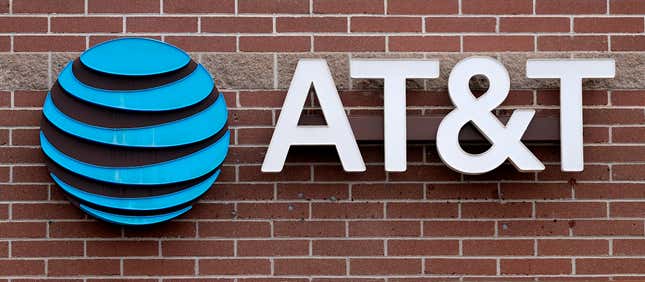 FILE - The company logo hangs over the door to an AT&amp;T store Thursday, Feb. 22, 2024, in Denver. AT&amp;T says it will give affected customers $5 each to compensate for last week&#39;s cellphone network outage that left many without service for hours.(AP Photo/David Zalubowski, File)