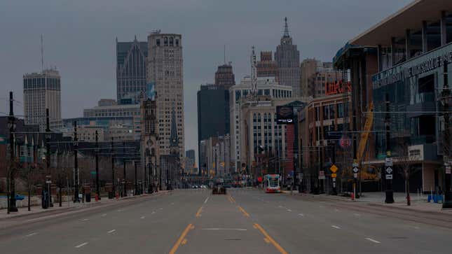 A photo of an empty street in the middle of Detroit. 