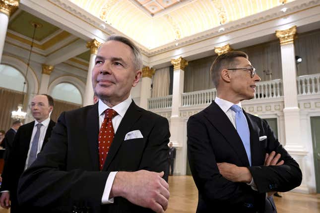 Leaders after the early vote results, National Coalition Party candidate Alexander Stubb, right, Social Movement candidate Pekka Haavisto foreground and Finns Party presidential candidate Jussi Halla-aho in the background, stand during a Presidential election event, at the Helsinki City Hall, in Helsinki, Finland, Sunday, Jan. 28, 2024. A projection in Finland says Alexander Stubb has won the first round of the presidential election to set up a Feb 11 runoff. (Markku Ulander/Lehtikuva via AP)