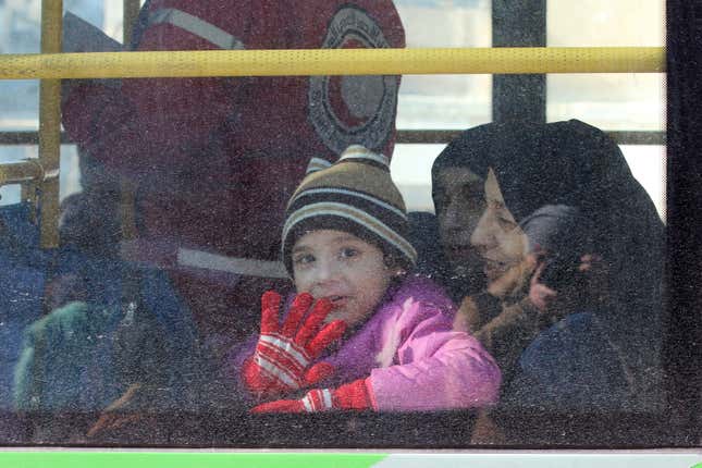 A child inside a bus evacuating people from a rebel-held sector of eastern Aleppo. (Reuters/Abdalrhman Ismail)