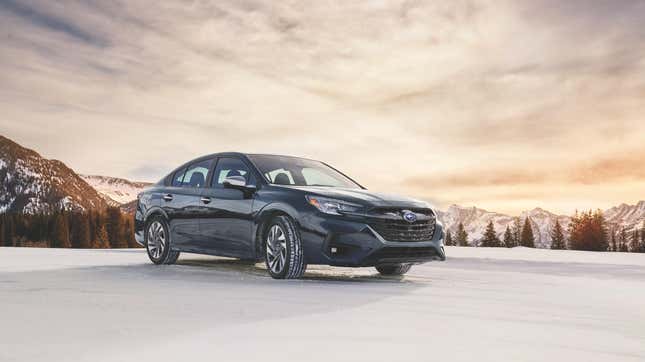 A navy blue Subaru Legacy parked on snow