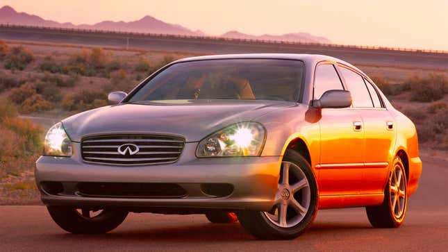 A photo of a silver Infiniti sedan taken at sunset. 