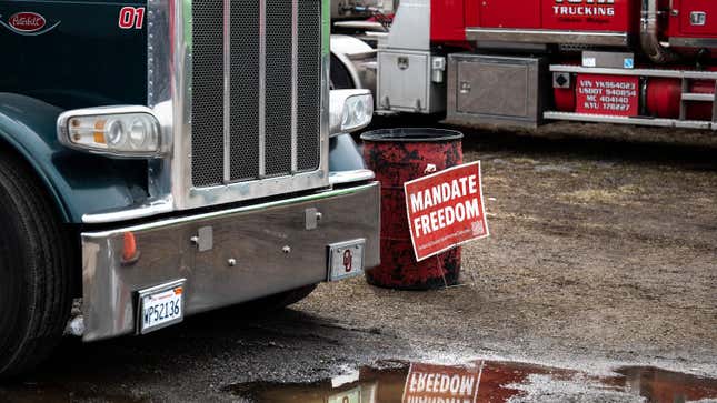 A placard reading Mandate Freedom rests on the ground as demonstrators prepare to depart Hagerstown Speedway in Hagerstown, Maryland, on March 7, 2022, during “The People’s Convoy” event. - The convoy has called on US President Joe Biden to end vaccine and other Covid-19 pandemic mandates while modeling themselves after Canadian drivers who had occupied the center of Ottawa in a similar protest. 