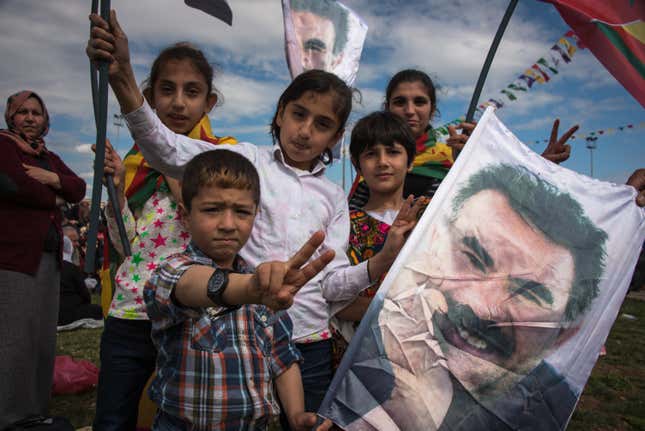Children pose with flags baring Ocalan’s face. Until the 2000, it was illegal to teach the Kurdish language in Turkish schools.