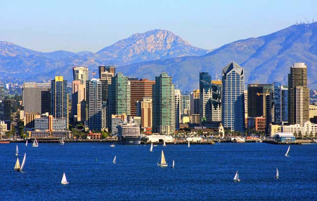 San Diego skyline from bay with mountains in background.