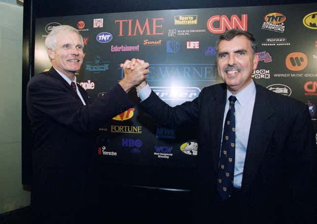 FILE - Turner Broadcasting Chairman and President Ted Turner, left, and Time Warner Chairman and CEO Gerald Levin pose for photographers prior to a news conference at the Time Life Building, Friday, Sept. 22, 1995, in New York. Levin, who led Time Warner Media into a disastrous $112 billion merger with the internet provider America Online, died Wednesday, March 13, 2024. He was 84. (AP Photo/Richard Drew, File)