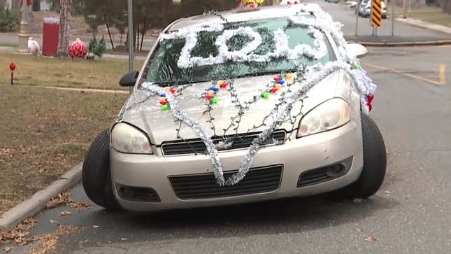 Image for article titled Neighborhood Gets Into The Holiday Spirit By Decorating An Abandoned Car