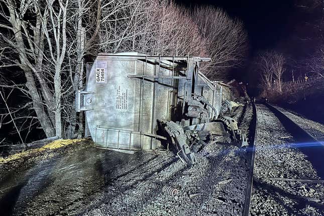 In this image provided by New York State Department of Environmental Conservation, train cars lie on their sides after a train derailed, Wednesday evening, Feb. 7, 2024, in Valley Falls, N.Y. Authorities say 10 cars of a 94-car cargo train carrying plastic pellets and cooking oil, derailed in upstate New York, with two ending up in a river. (Basil Seggos/ New York State Department of Environmental Conservation via AP)