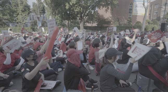Women cover their faces at a protest against spy cams in Seoul.