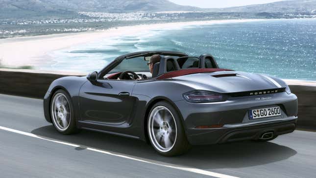 A gray Boxster driving next to the ocean