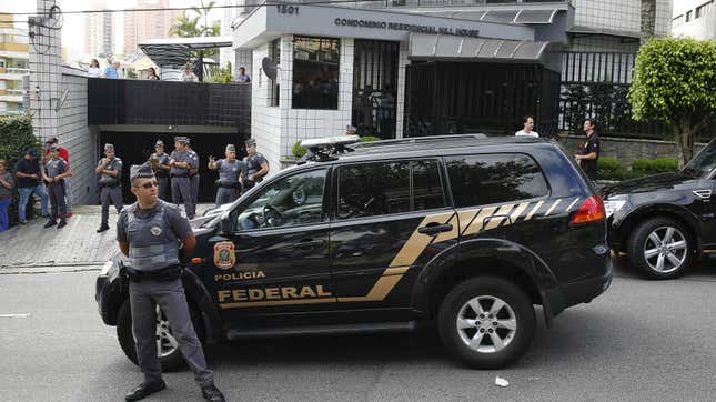 Police officers outside the residence of Brazil’s former President Luiz Inacio Lula da Silva in Sao Paulo.