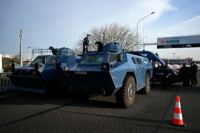 A gendarme stands atop a military vehicle at the entrance of the Rungis International Market, which supplies the capital and surrounding region with much of its fresh food, Monday, Jan. 29, 2024 south of Paris. Protesting farmers intended to encircle Paris with barricades of tractors, aiming to lay siege to France&#39;s seat of power in a battle with the government over the future of their industry shaken by the repercussions of the Ukraine war. (AP Photo/Christophe Ena)