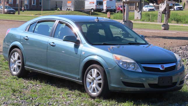 a light green saturn aura parked on grass