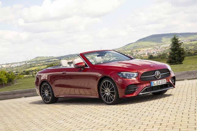 A red E-Class cabriolet parked at a golf course