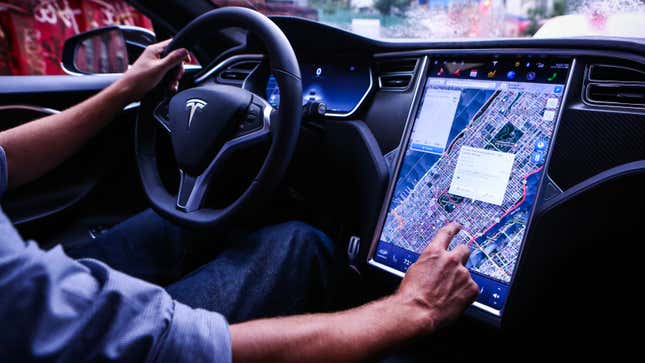 A photo of someone using a touchscreen in their Tesla.  