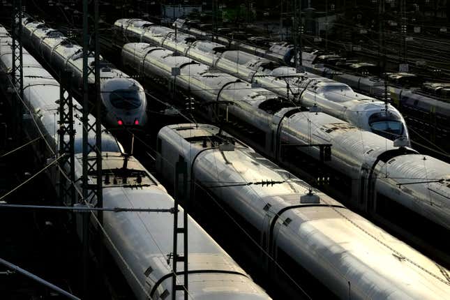 Trains are parked outside the train station in Munich, Germany, Thursday, Nov. 16, 2023. Germany’s national railway operator is running a drastically reduced service after a union called out drivers and others on a 20-hour strike aimed at increasing the pressure in a bitter dispute over pay and working hours. (AP Photo/Matthias Schrader)