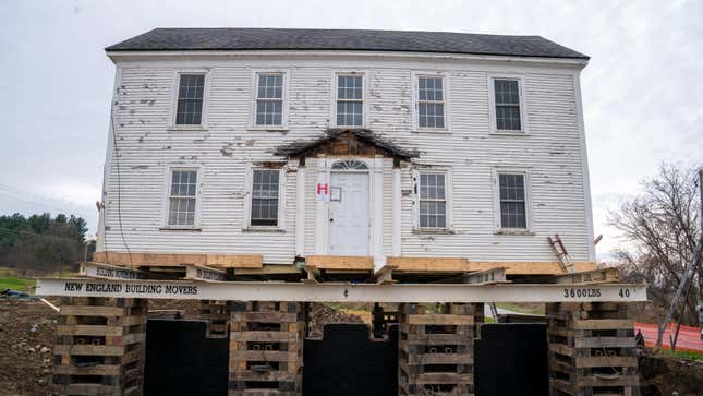A house built in 1810 sits on blocks as its foundation and wooden structure are rebuilt.