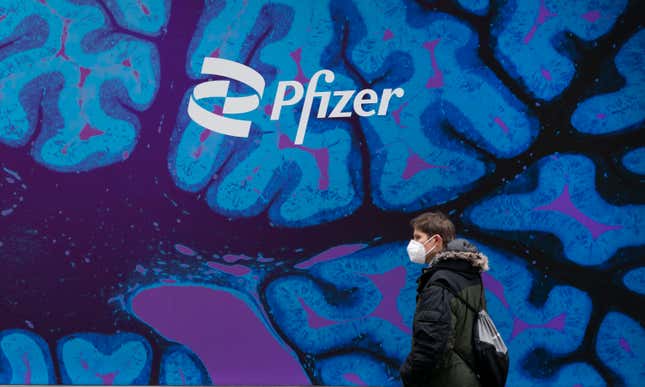 FILE - A man walks by Pfizer headquarters, Friday, Feb. 5, 2021 in New York. Pfizer released a financial outlook for next year that that doesn&#39;t match with Wall Street expectations as sales of COVID-19 products slide. Shares tumbled more than 7% before the opening bell Wednesday, Dec. 13, 2023. (AP Photo/Mark Lennihan, File)