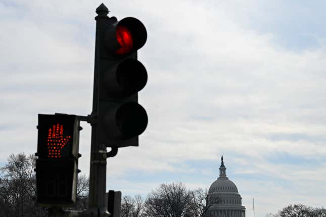 A red traffic light is seen near the US Capitol in Washington, DC on February 1, 2020.