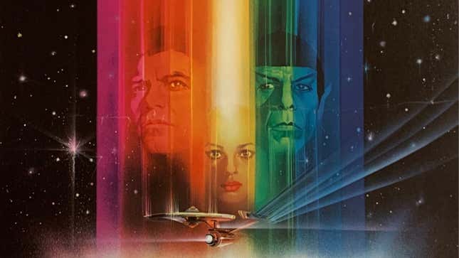 The faces of Kirk, Spock, and Ilia appear in a prismatic rainbow in space.