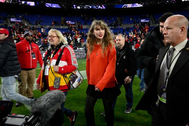 Taylor Swift, right, walks with Donna Kelce on the field after the AFC Championship NFL football game between the Baltimore Ravens and the Kansas City Chiefs, Sunday, Jan. 28, 2024, in Baltimore. (AP Photo/Nick Wass)