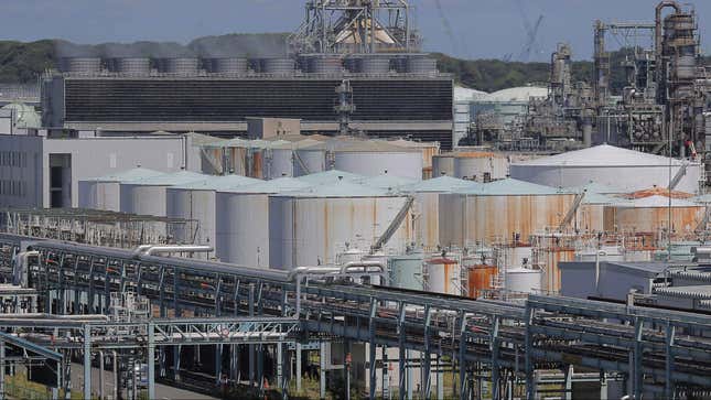 Oil storage tanks are seen at an industrial area in Yokohama, south of Tokyo, Wednesday, Aug. 22, 2012. Japan slipped back into a trade deficit in July, as exports languished and imports of gas and generating equipment surged, the Ministry of Finance reported Wednesday.