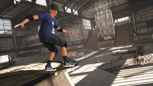 A video game rendition of Tony Hawk is grinding along the edge of a quarter-pipe on a skateboard. He is wearing a black helmet, blue shirt, and black shorts.