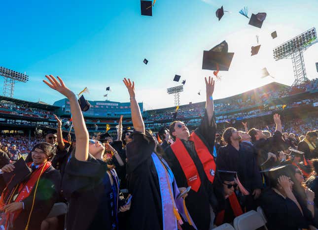 Students throwing their caps in the air.