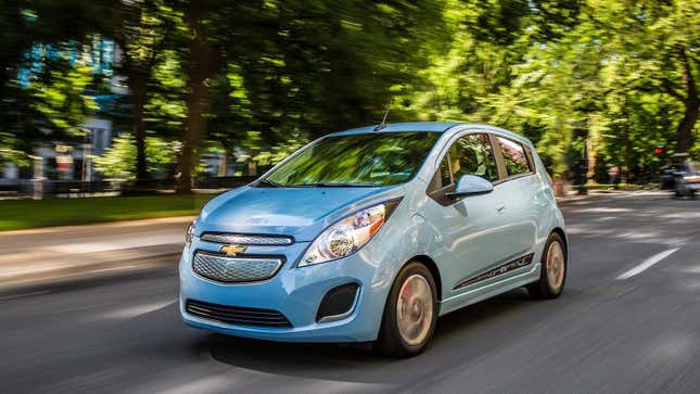 Ein blauer Chevrolet Spark EV fährt vor einem Park 