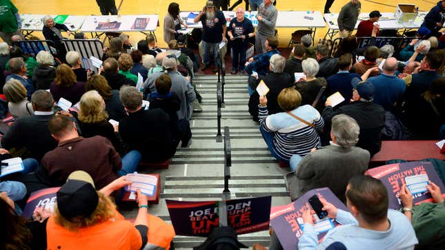 Caucus goers are handed their first-choice cards during caucusing at Abraham Lincoln High School in Des Moines, Iowa, on February 3, 2020.