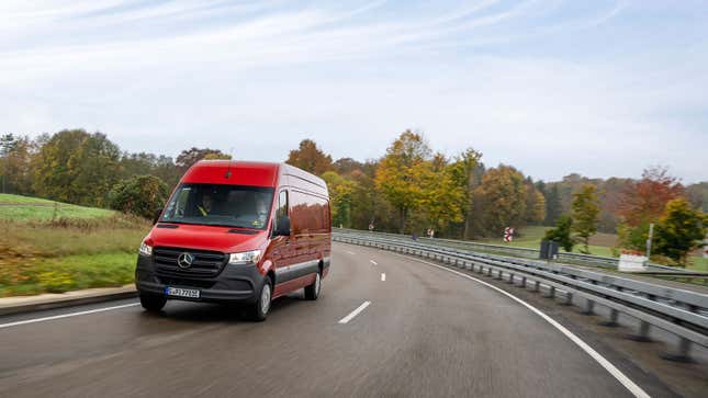 A photo of the front end of an electric Mercedes Sprinter van driving on a highway. 