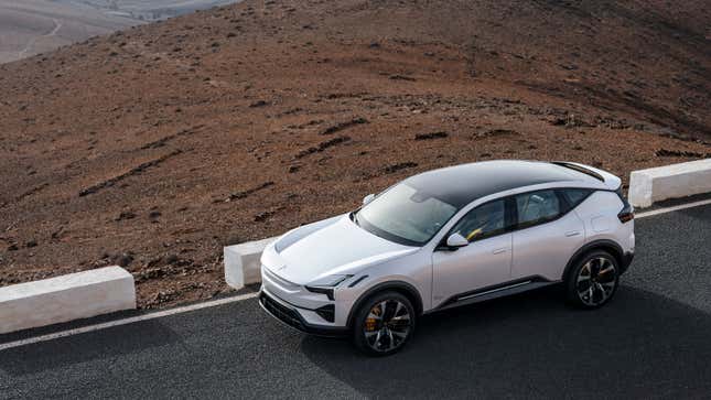 A photo of a white Polestar 3 SUV driving on a highway. 