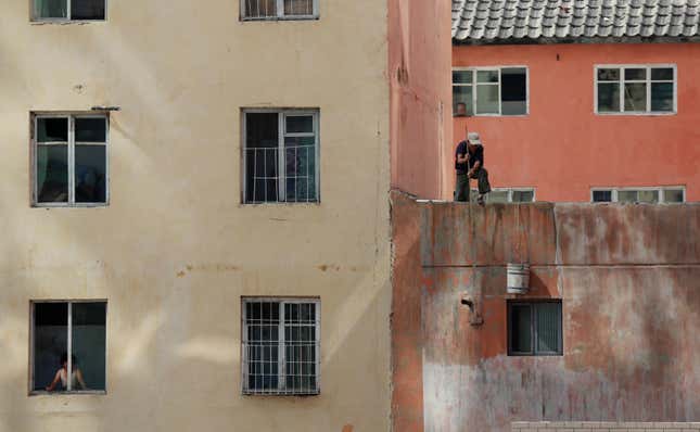 A man paints his house in Pyongyang.